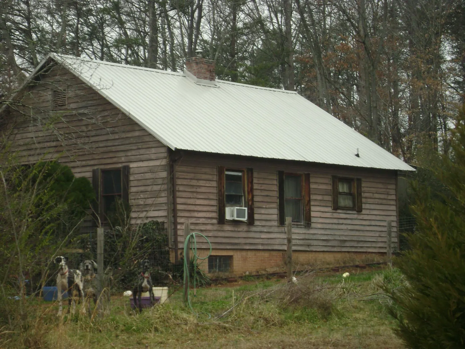 White metal roof on an old wood sided farmhouse, from a Metal Roof Installation job in Martell
